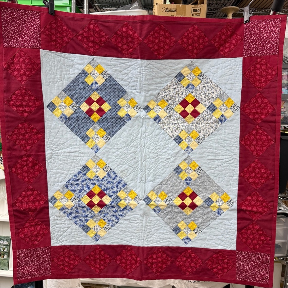 Patchwork Quilt with Red and Blue Accents